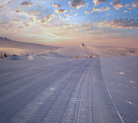 Alpine resort prepared ski slopes and lifts. Pre sunrise morning mountain ridge view. Dragobrat, Ukraine Carpathians.の写真素材