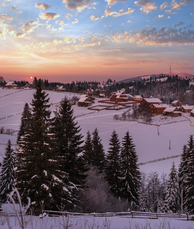 Small and quiet alpine village and winter sunrise snowy mountains around, Voronenko, Carpathian, Ukraine.の写真素材