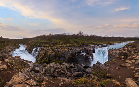 Picturesque waterfall Hlauptungufoss autumn view. Season changing in southern Highlands of Iceland.の写真素材