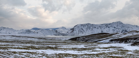 Colorful Landmannalaugar mountains under snow cover in autumn, southern Highlands of Iceland. Frostastadavatn lake at the foot of the mountains.の写真素材