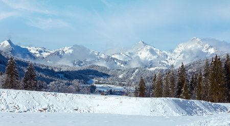 Winter mountain country landscape with fir trees (Heiterwang outskirts, Austria, Tirol)の写真素材