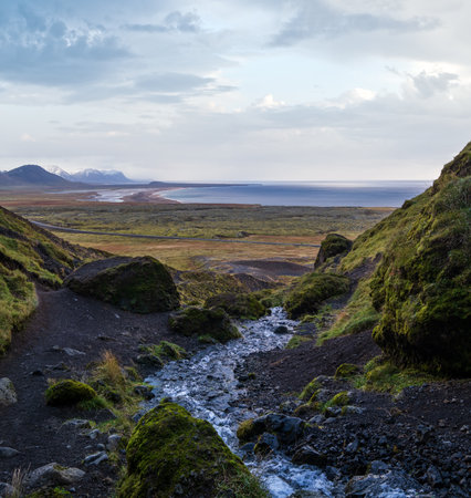 View during auto trip in West Iceland highlands, Snaefellsnes peninsula, Snaefellsjokull National Park. Spectacular volcanic tundra view from Raudfeldsgja Gorge along stream to ocean coast.の写真素材