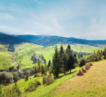 Beautiful summer mountain and small village on mountainside (Carpathian. Ukraine)の写真素材