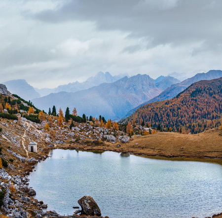 Overcast morning autumn alpine Dolomites mountain scene. Peaceful Valparola Path and Lake view, Belluno, Italy.   Picturesque traveling, seasonal, and nature beauty concept scene.の写真素材