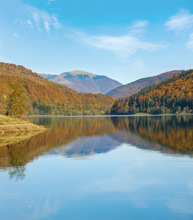 Vilshany water reservoir on the Tereblya river, Transcarpathia, Ukraine. Picturesque lake with clouds reflection. Beautiful autumn day in Carpathian Mountains.の写真素材