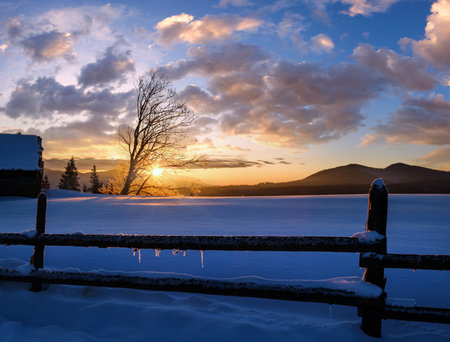 Small and quiet alpine village outskirts and winter sunrise snowy mountains around, Voronenko, Carpathian, Ukraine.の写真素材