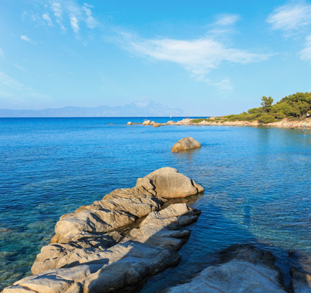 Aegean sea coast landscape and Mount Athos in mist, view from Orange Beach (Chalkidiki, Greece). People are unrecognizable.の写真素材