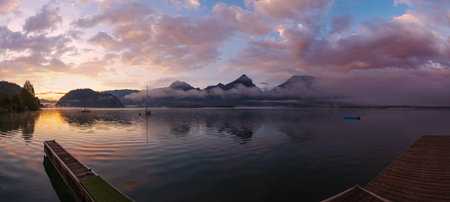 Peaceful autumn Alps mountain lake. Sunrise Wolfgangsee lake view, St. Wolfgang im Salzkammergut, Upper Austria.の写真素材
