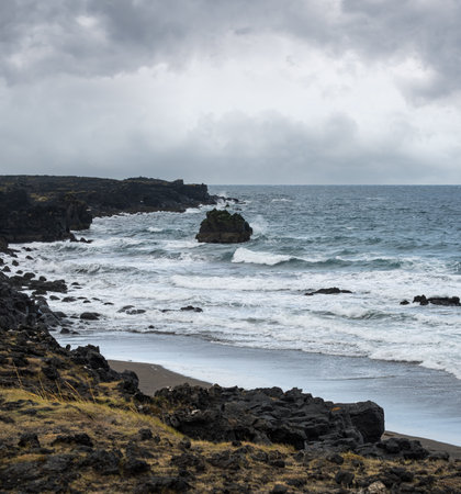 View during auto trip in West Iceland, Snaefellsnes peninsula, Skardsvik Beach. Spectacular black volcanic rocky ocean coast.の写真素材