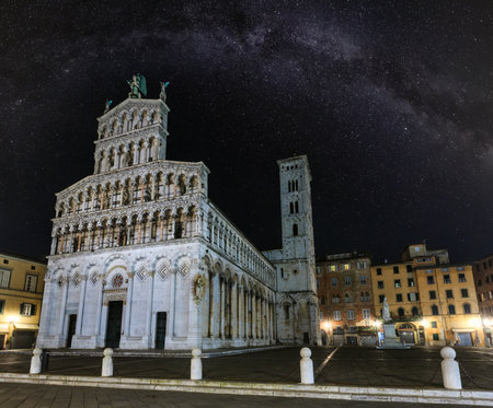 Lucca (Tuscany, central Italy) city night view with Milky Way stars sky. The San Michele in Foro (Roman Catholic basilica church). Facade build in 13th century.の写真素材