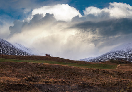 Beautiful mountain view during auto trip in Iceland. Spectacular Icelandic landscape with  scenic nature: mountains, fields, clouds, glaciers, rocks.の写真素材