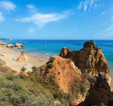 Evening sandy beach Praia dos Tres Castelos with rock formations, Portimao, Algarve, Portugal. Top view. Peoples are unrecognizable.の写真素材