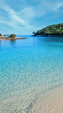 Beautiful Ionian Sea with clear turquoise water and morning summer coast view from beach (Ksamil, Albania).の写真素材