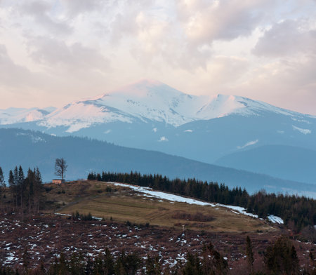 Early morning spring Carpathian mountains plateau landscape with snow-covered ridge tops in far, Ukraine.の写真素材