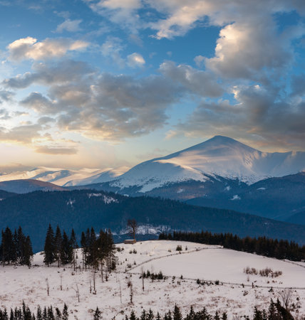 Evening twilight winter snow covered alp mountain ridge (Ukraine, Carpathian Mountains, Chornohora Range - Hoverla, Petros and other mounts, scenery view from Yablunytsia pass).の写真素材