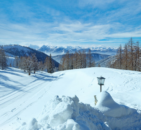 Winter hazy view from Dachstein mountain massif (Austria) and lamp near hotel entranceの写真素材
