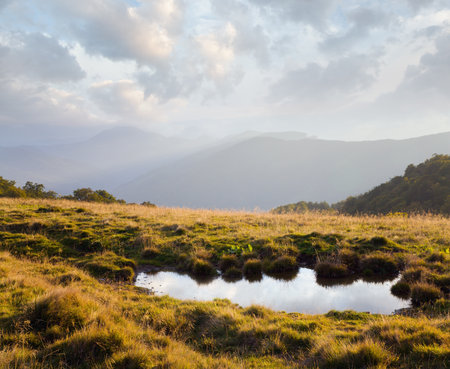 Cloud reflection on evening autumn mountain plateau.の写真素材