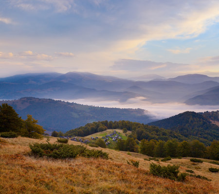 Carpathian Mountains (Ukraine) autumn landscape with cattle-breeding farm and country road.の写真素材