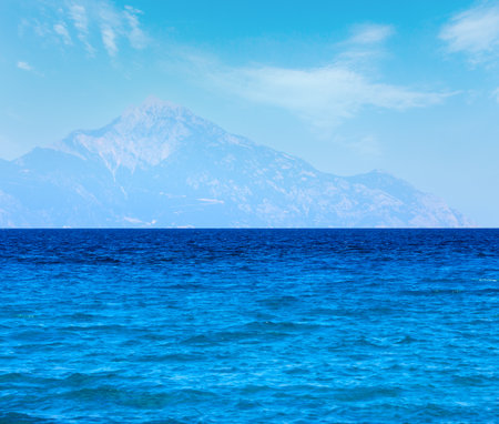 Aegean sea coast landscape with aquamarine water and Mount Athos in mist (view from Chalkidiki, Greece).の写真素材