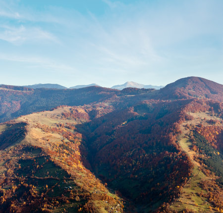 Autumn Carpathian Mountains landscape with multicolored trees and village outskirts on slope (view from Rakhiv pass, Transcarpathia, Ukraine).の写真素材