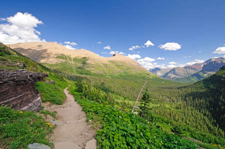 The iceberg lake trail in Glacier National Park looking into the swiftcurrent valleyの写真素材