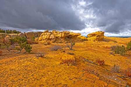 Sun Breaking Through the Clouds on a Colorful Sandstone Ridge in El Malpais National Monument in New Mexicoの写真素材