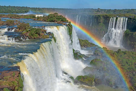 Iridescent Ranbow Over the Falls at Iguazu Falls in Brazilの写真素材