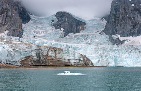 Glacier Flowing Past a Nunatak in the Arctic in Hornsund in the Svalbard Islandsの写真素材