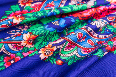 Beautiful blue cotton Russian shawl with vivid floral design, traditional winter scarf background.