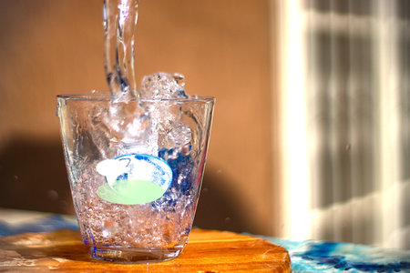 flow of water poured into a glass