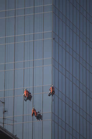 some window cleaners for skyscrapers at workの写真素材