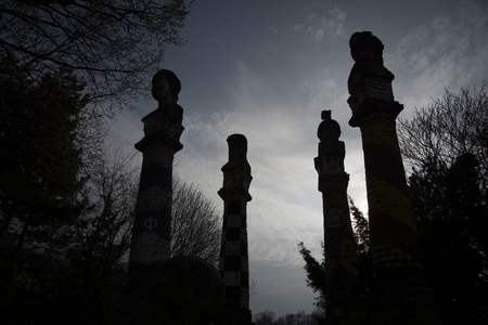 Twilight of the Gods! With pride they are ascending toward the skies. Silhouettes of the statues in the park against the dimming sky.の写真素材