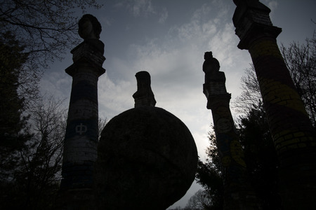 Twilight of the Gods! Dark sun is setting down. Silhouettes of the statues in the park against the...