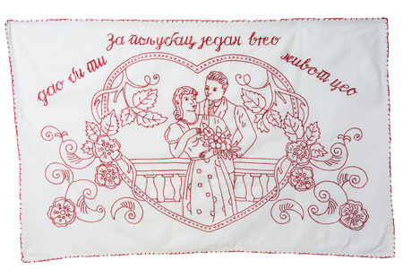 Vintage redwork embroidery kitchen towel, red-bordered. It has written on it For one hot kiss I would give you my whole life, in the Serbian language. Isolated on white background. Working path saved.の写真素材
