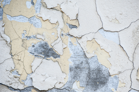 Texture of the wall with shabby paint of white and yellow tonesの写真素材