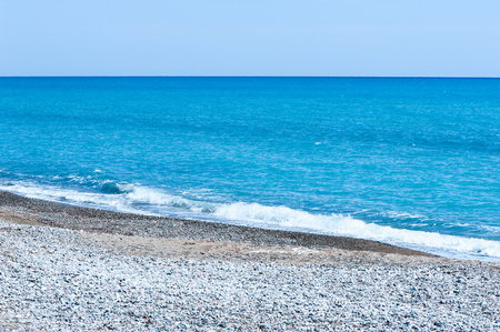 Beautiful blue sea and stony shoreの写真素材