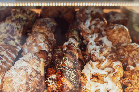 Cakes and buns in the coffee house. Puff pastries with poppy seeds and nuts, croissantsの写真素材