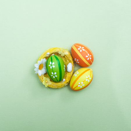 Easter theme. Decorated Easter eggs on a green background. Minimalism, View from above, flat lay