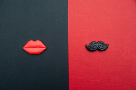 Ð¡oncept of male and female. Flat Lay, red and black, red lips and black mustache, as a symbol of man and woman. Valentine day loveの写真素材