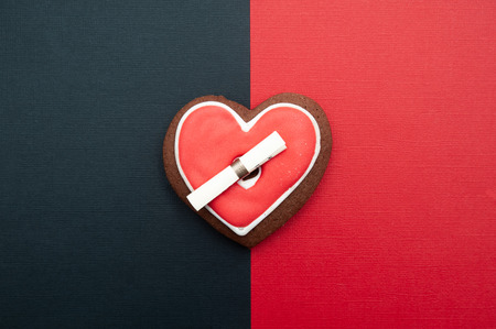 Heart cookies as a symbol connecting the man and woman on a red and black background, love and family. Love Concept, Valentine's Dayの写真素材