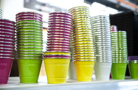 Multicolored empty flower pots on the counter in the storeの写真素材
