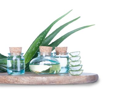 Aloe oil in bottles and a living plant isolated on white の写真素材