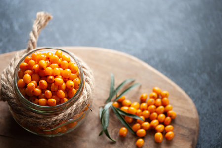 Sea buckthorn berries in a jar, orange healthy berries, macroの写真素材