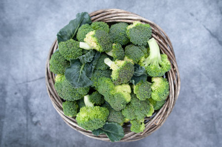Broccoli inflorescences in the basket, top view. Green fresh cabbageの写真素材