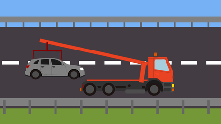 Tow truck picking up a vehicle on the roadの写真素材