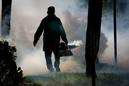 A man fumigates for mosquitoesの写真素材