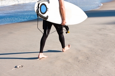 Surfer walking on the beach