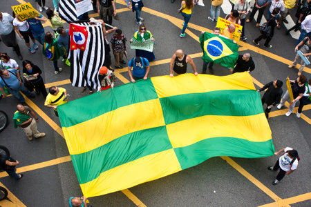 Sao Paulo, Brazil - November 15. Some protesters marching on Paulista Avenue holding signs with messages against the corruption of brazilian goverment. They were also protesting against Foro de Sao Paulo and irregularities on Petrobras on November 15th, 2のeditorial素材