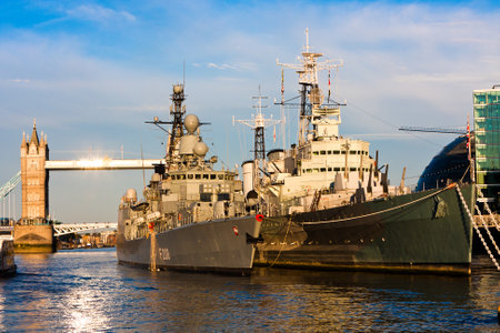 Two warships of World War II, the British Navy, with Tower Bridge in the background.