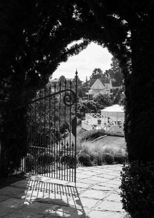Campos do Jordao, Brazil, July 26, 2016 black and white photograph of villas in Campos do Jordao. In the foreground, craft gate in cast iron.のeditorial素材